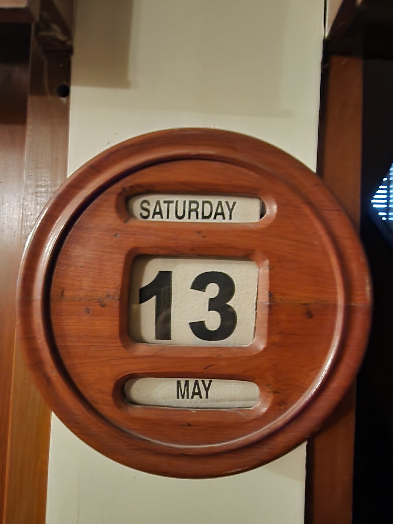 A manual wooden wall calendar