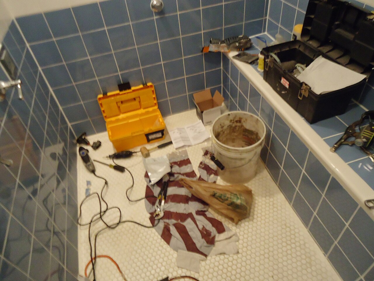Plumbing tools laid out on a floor